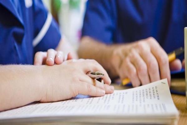 Nurses with paperwork