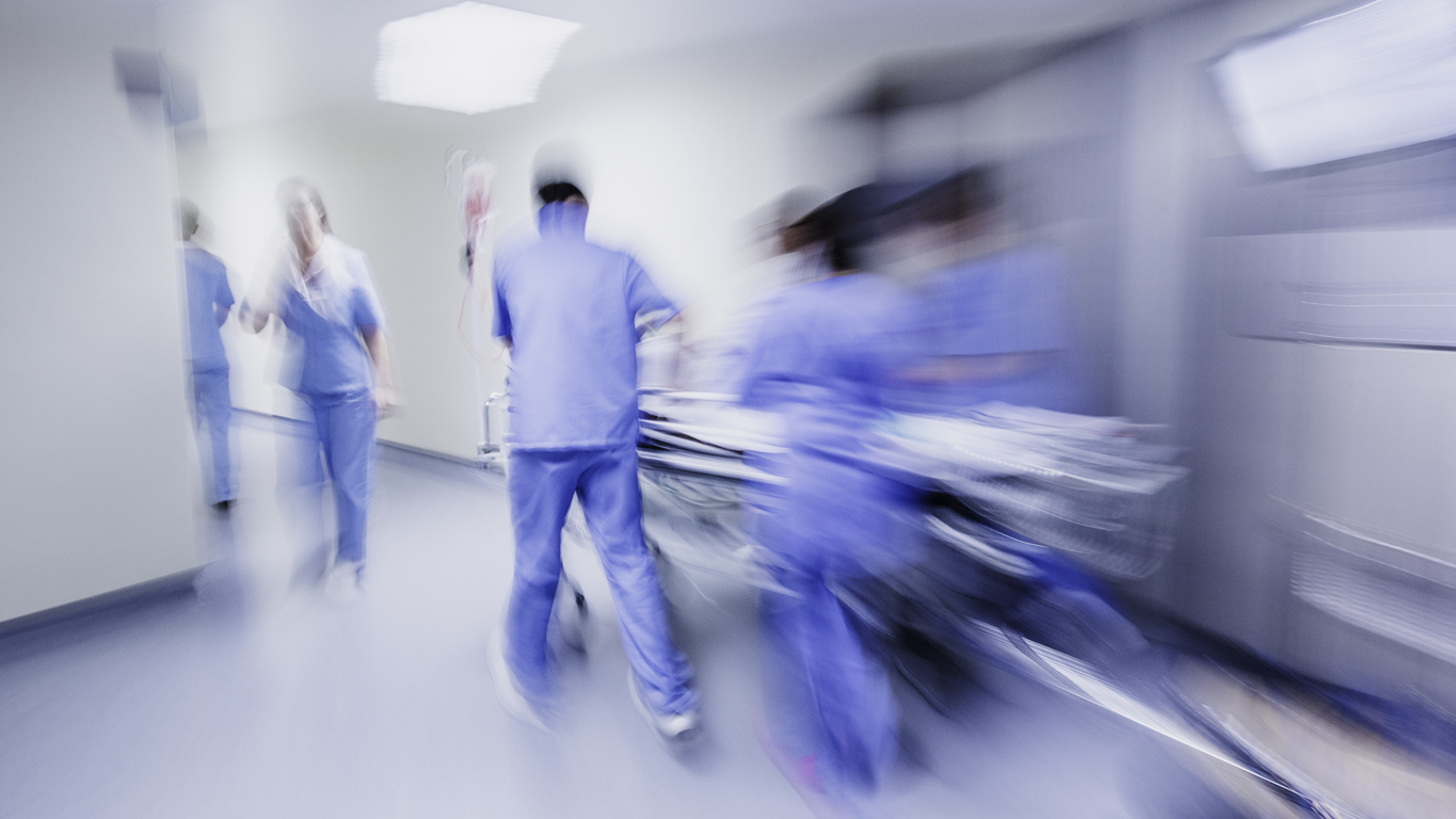 nurses pushing bed in motion