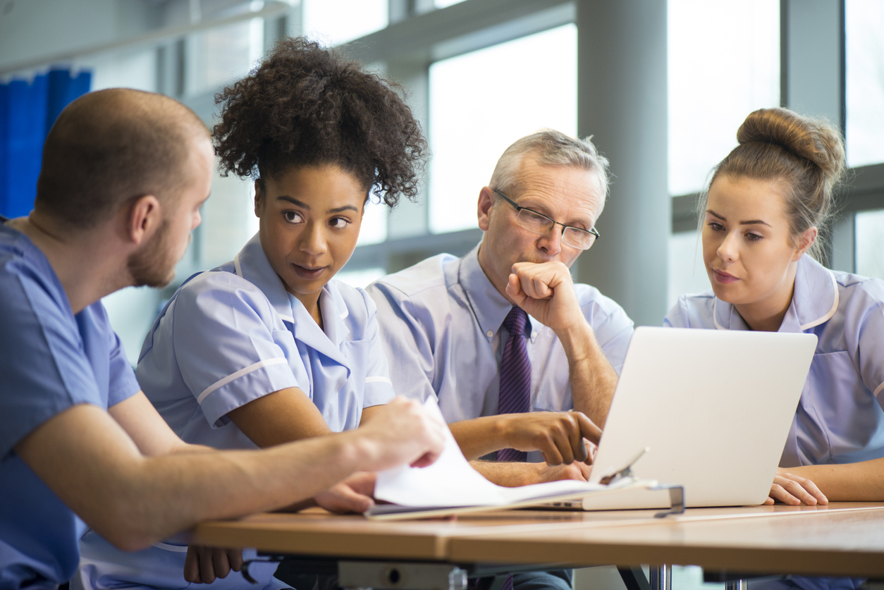 nurses looking into laptop
